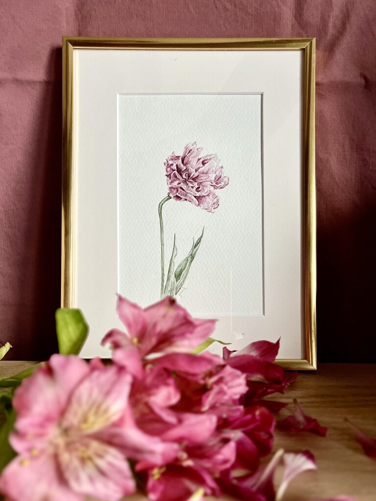 Framed watercolor painting featuring a flower
